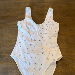 White body suit with blue floral details